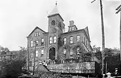 Lincoln School Wheeling, West Virginia, with people lining a fence in front of it