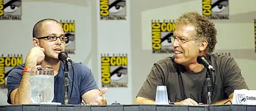 Damon Lindelof and Carlton Cuse sitting, speaking into microphones.