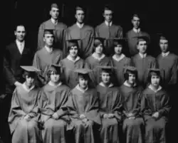 The photo is a black and white image of the Rogersville Class of 1927, showing three rows of 16 graduates alongside what appears to be the principal.