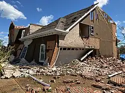 A severely-damaged brick house