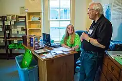 Ingersoll Museum docent Frances Emerson welcomes one of 55 Ingersoll Conference participants who visited the Birthplace Museum during the “Robert Green Ingersoll and the Reform Imperative” conference motor coach tour, August 17, 2104. Photo by Monica Harmsen.