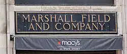 The original State Street entrance sign bronze plaque for Marshall Field and Company with adjacent new Macy's signage, Chicago, 2005