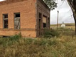 Abandoned bank and church in Mildred, MT