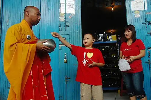 A Mahāyāna monk performs alms-gathering before the 2010 Vesak holiday in Magelang City, Central Java, Indonesia