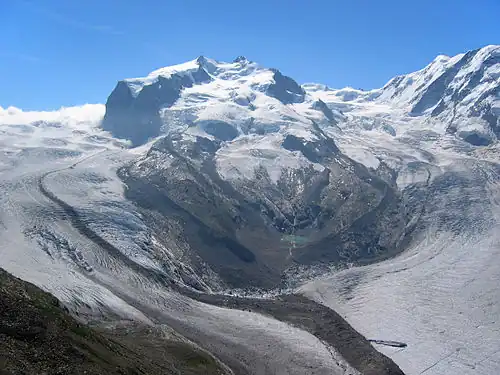 2005: The connection between the Gorner Glacier and Grenzgletscher is still present and the moraine is still fed by the former; the old Monte Rosa Hut (2,795 m) is recognizable above the left over, north-eastern lateral moraine of the Grenzgletscher (in the middle, right).