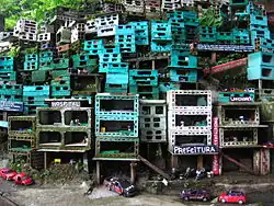 Morrinho storefronts with vehicles parked on the street and people seen through the windows