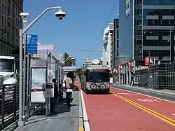 A bus stop with bus in the median of an urban arterial