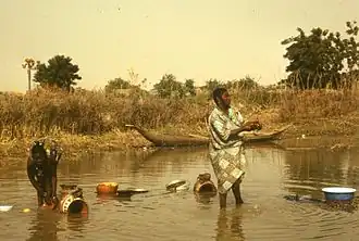 Women washing dishes in Karma, 1976