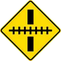 Railway crossing ahead at a right angle
