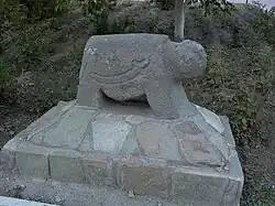 Ram-shaped grave monument embedded in concrete