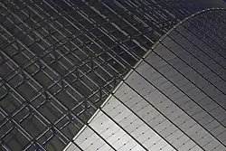 Building detail: transition from glass to titanium.