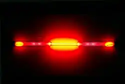 A glass tube with a red glow emanating from it