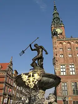 The fountain with the Polish Eagle in the foreground and the Main Town Hall in the background