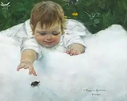 A little girl catching a beetle on the white quilt