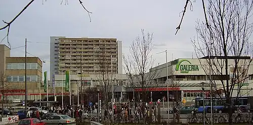 Olympia shopping mall from afar, street view, on partly cloudy winter day
