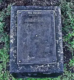 A plaque with text about the statue