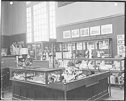 Two unidentified female food and drug inspectors looking through microscopes demonstrating pork inspection