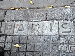 Street name on pavement: Carrer de París.