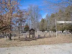 Backside of the cemetery, with a visitor's sheet available in the wooden structure