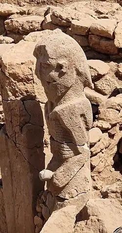 Karahan Tepe anthropomorphic statue (2.3 meters), naked and holding phallus with both hands. 10,000-9,500 BC.[18]