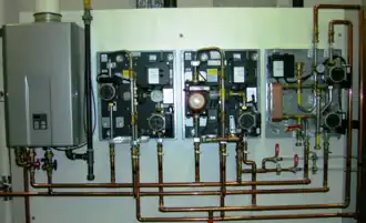 Modern factory assembled hydronic control appliances for underfloor heating and cooling, shown with covers off