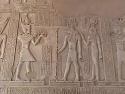 A Ptolemaic dynasty ruler with the cartouche "Ptolemy" before Sobek and Hathor, Kom Ombo.