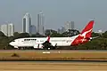 Boeing 737-800 at Perth Airport with the city of Perth in the background (2004).