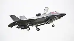 F-35B showing weapon's bay inboard doors open to capture rising fountain flow