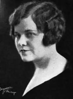 A white woman with dark wavy hair cut in a bob style