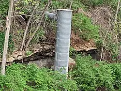 Raytown Limestone Formation and underlying Muncie Creek Shale, Iola Formation, Upper Zarah Subgroup, Kansas City Group. Note the softer shale layer has eroded and undercut the limestone formation. (Railroad cut in Raytown, Missouri.)
