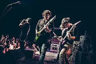 Performing in 2014 at the Skyway Theatre in Minneapolis. Depicted from left to right: Jake Wolf, Charles Caswell, Francis Xayana, Patrick Somoulay, and Cam Murray (obscured by monitors).