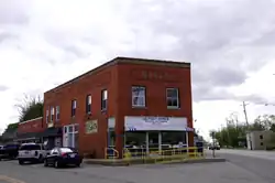 The intersection of U.S. Route 6 and County Road X. Site of the Ottes building, 1916, now home to the Ridgeville Corners Post Office and local businesses.