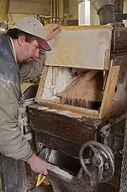 Roll Stand in Roller Mill with mill worker.