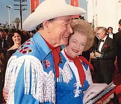 Roy Rogers in fringed Western shirt and Dale Evans in matching fringe jacket