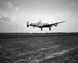 Avro Lancaster B.3, ED831 'WS-H', of No. 9 Squadron taking off at RAF Bardney, Lincolnshire, for a raid on the Zeppelin works at Friedrichshafen in Germany.