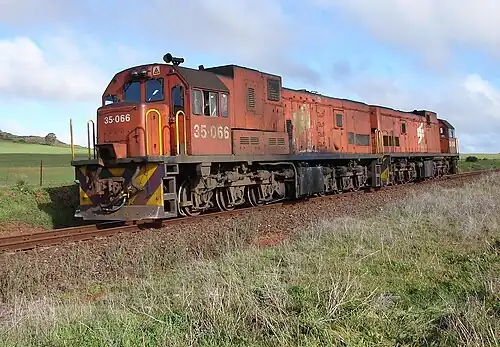 No. 35-066 in Spoornet orange livery and without a saddle hood, Biesiesfontein Farm near Moorreesburg, 9 June 2007