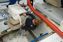 Sandra Magnus in toe socks (STS-135).