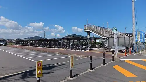 A view of the station forecourt, showing the bike sheds. The station building is outside the frame, to the right.
