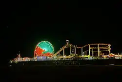 Santa Monica Pier at night with Ferris wheel lit up in green and red
