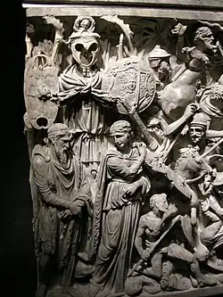 Detail of the front-left side: trophies, barbarian chief and presumed consort.[72]