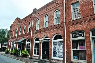 Immediately around the corner to the right, 310–312 West Congress Street, the frontages of the previous properties