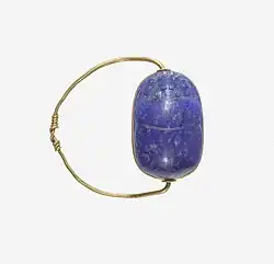 Ancient Egyptian scarab finger ring; 1850–1750 BC; lapis lazuli scarab set in gold plate and on a gold wire ring lapis-lazuli; diameter: 2.5 cm (0.98 in), the scarab: 1.8 cm (0.71 in); Metropolitan Museum of Art