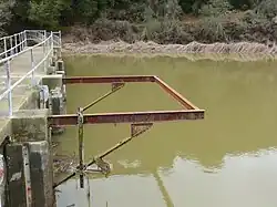 A photo showing a frame on Searsville Dam which at one time supported a diving platform