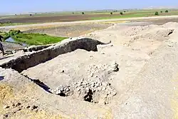 Excavatinons at Gird-i Qalrakh. Shahrizor Plain appears in the background