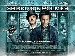 Robert Downey Jr. and Jude Law, in-character. The background is a window display, featuring shelves containing miscellaneous objects relating to the story. The poster reads "Sherlock Holmes" across the top, with the tagline "Holmes for the holiday" centered at the bottom. The poster is predominately turquoise coloured.