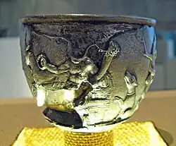 Cernunnos on the Lyon cup. A torc-wearing figure reclines in between a deer and a dog.: no 12 