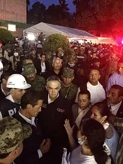 People talking to politicians and rescue workers