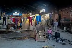 Shack housing within a larger building, children playing