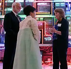 The South Korean President and museum officials standing in front of the artwork