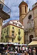 Weekly market on Plaça Major, with the Santa Maria church.